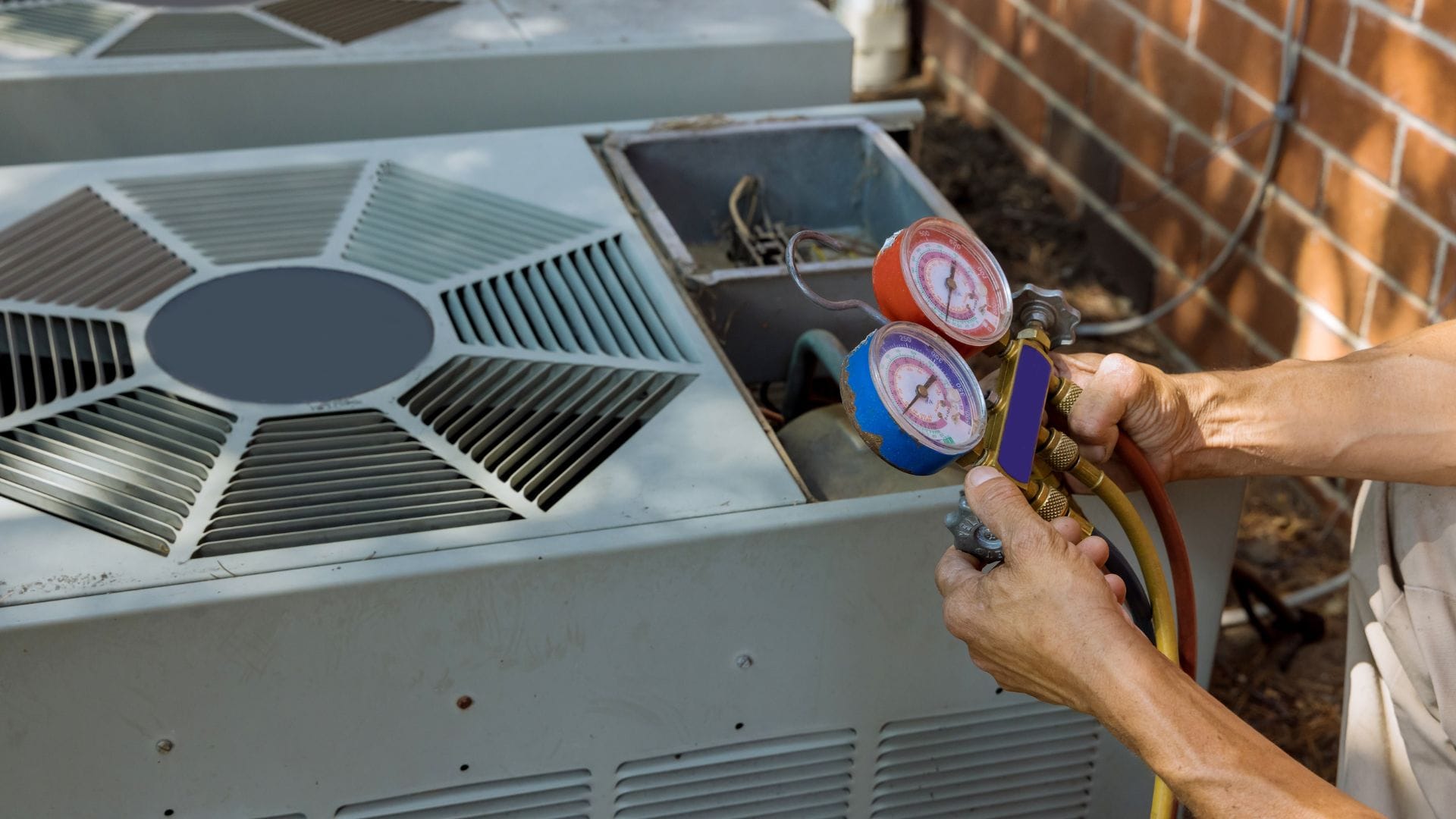 Advantage technician using refrigerant gauges to diagnose an AC unit