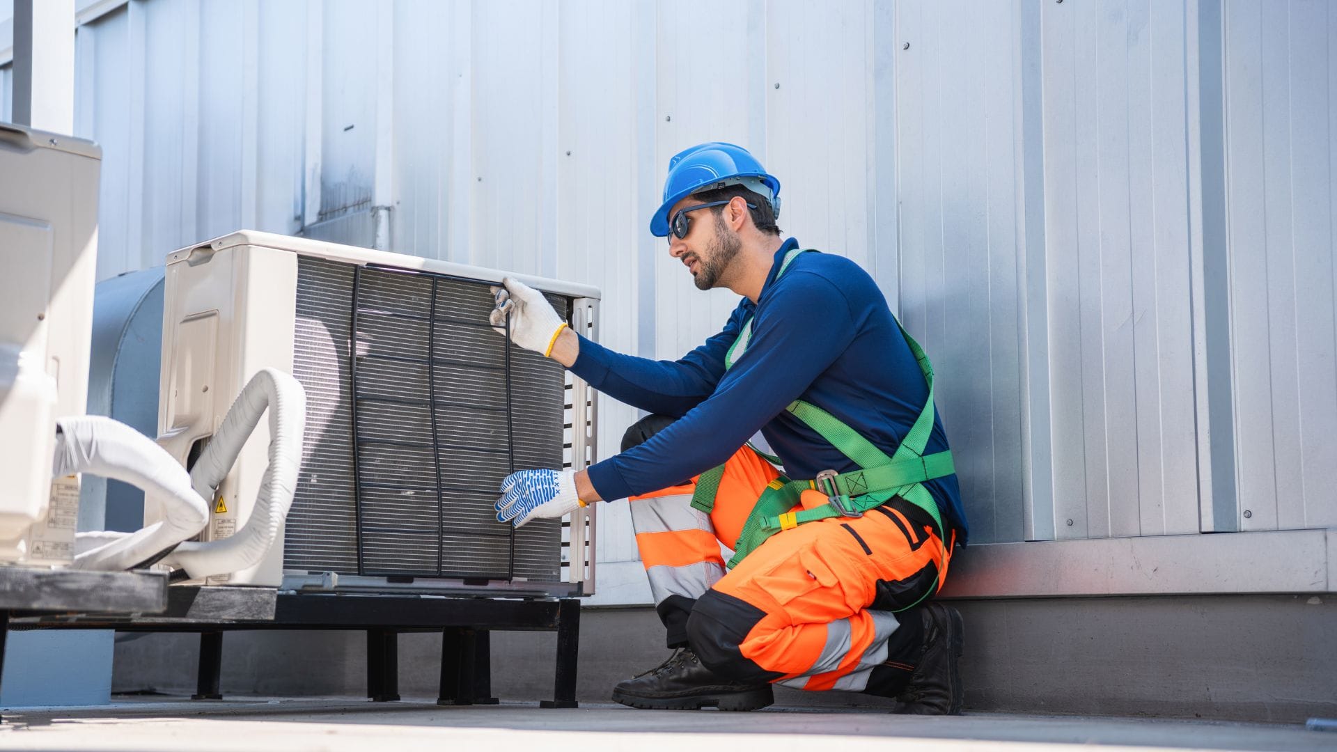 Technician inspecting outdoor AC components